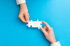 The,Man,And,Woman,Holds,In,Hand,A,Jigsaw,Puzzle.
