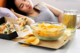 Asian,Woman,Sleep,After,Eating,Junk,Food,With,Pizza,,Potato