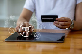 Close,Up,Woman,Hand,Using,Credit,Card,And,Tablet,Laptop