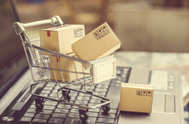 Paper,Boxes,In,A,Shopping,Cart,On,A,Laptop,Keyboard.