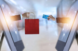 E-commerce,,Hand,Holding,Shopping,Bag,And,Credit,Card,From,Screen